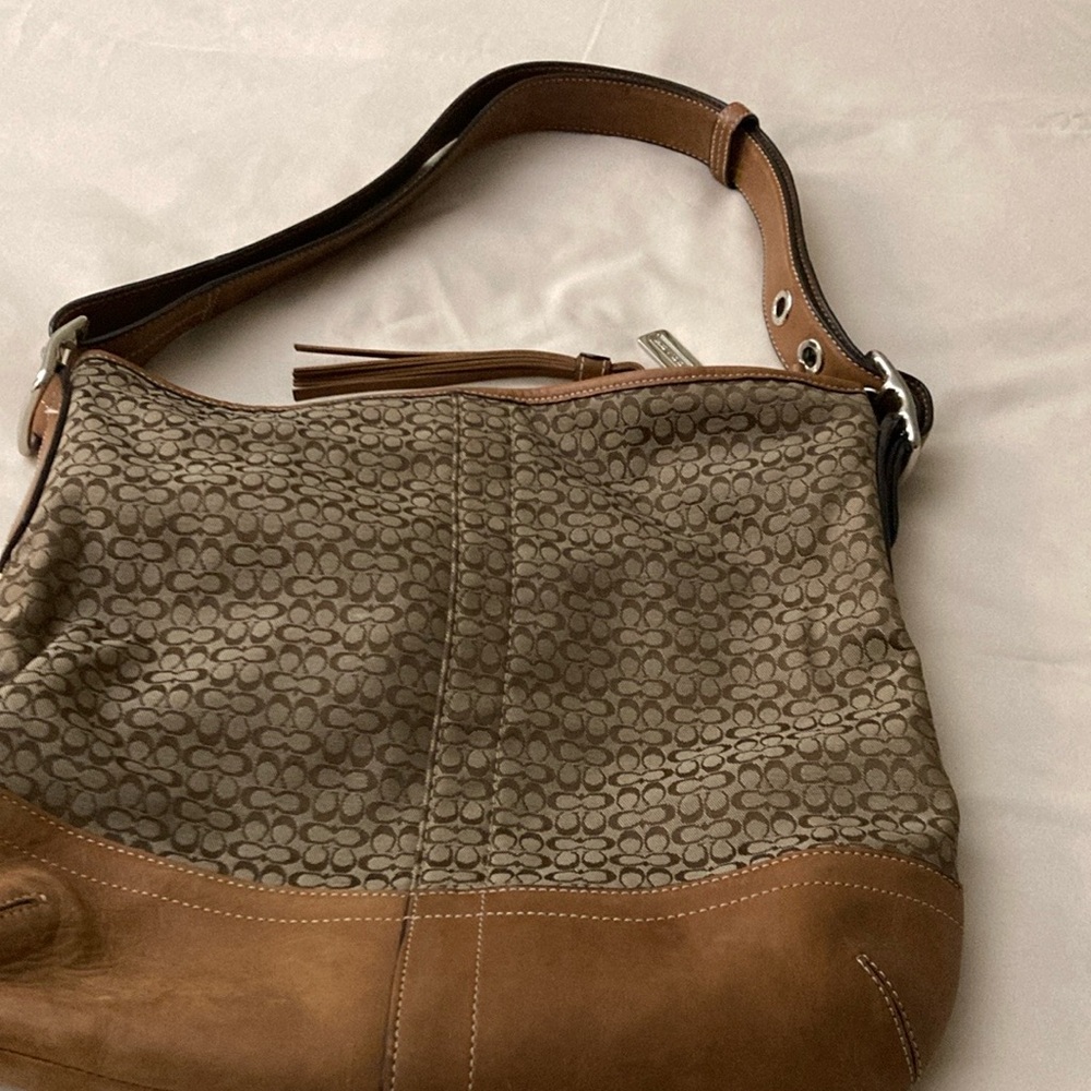 Coach tan purse with adjustable strap.